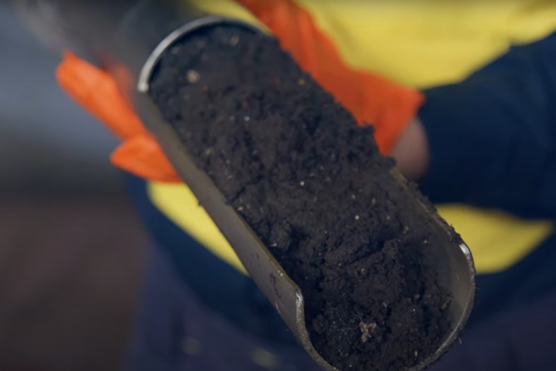 Employee showing what biosolids look like