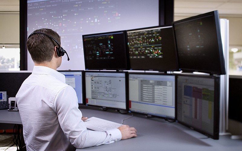 Image of man looking at data on screens