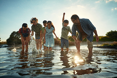 Children and adults playing in the water