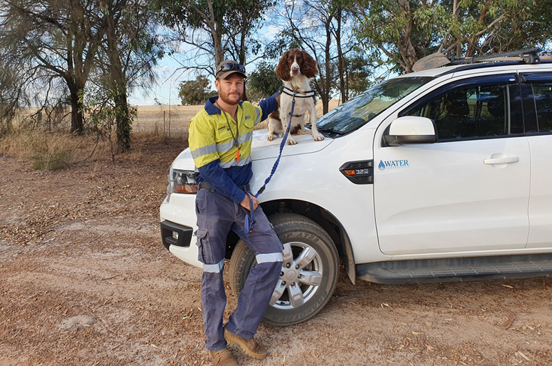 Andrew Blair and Kep standing by a Water Corporation car